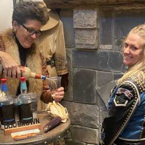 Amy Brown of Doc Brown Farm and Distillers pouring a Bourbon Cream for customer
